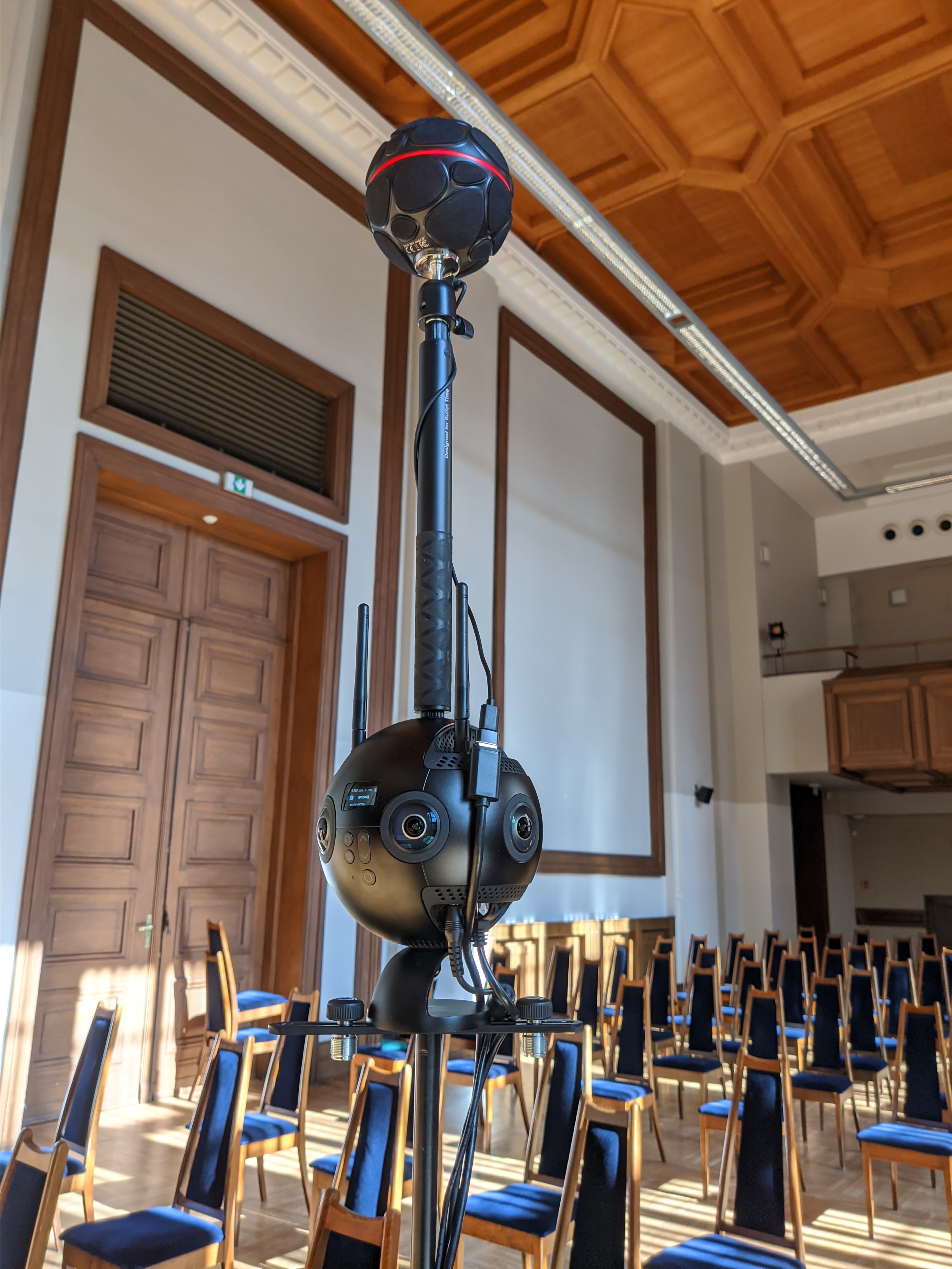 Zylia ZM-1 ambisonic microphone mounted above an Insta360 Pro 2 camera on a boom stand in the concert hall